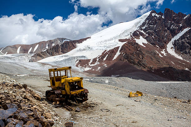 Abandoned bulldozer in mountains. Kyrgyzstan stock photo
