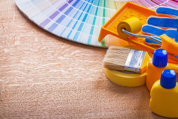 istock Paint tools and pantone color palette guide on wooden board 475421786