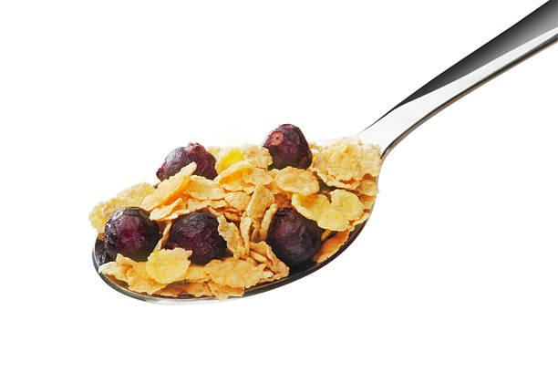 istock Cornflakes with fruits on the spoon 475422371