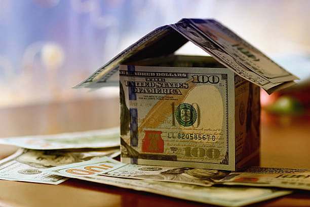 istock Real Estate dollar house background 475426238