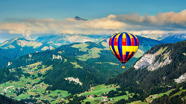 istock Panoramic view of mountains with a hot air balloon 475426258