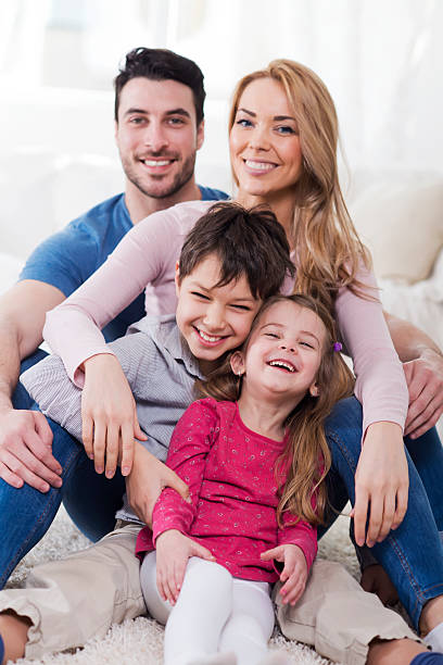 istock Beautiful smiling family at home 475426565