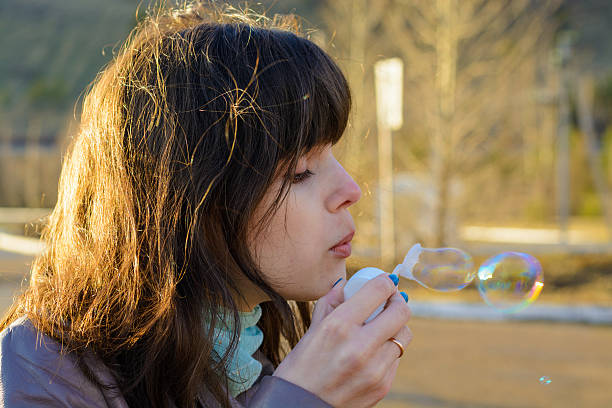 istock Woman blows a soap bubble 475427370
