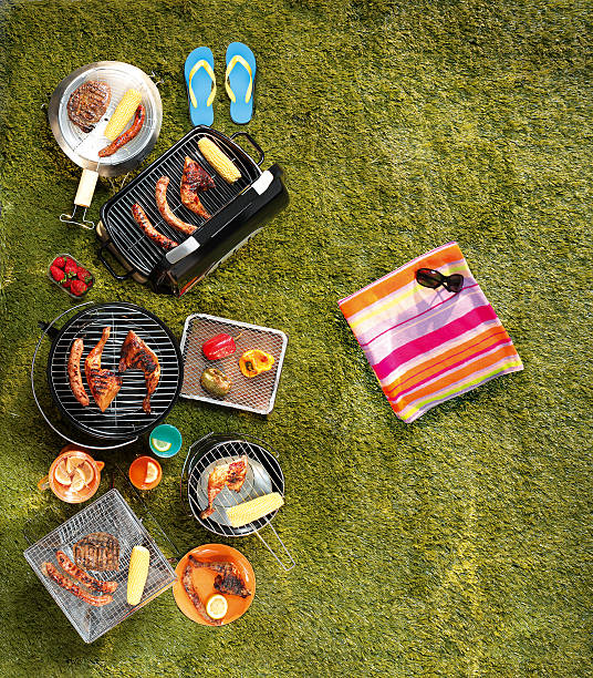 Nicely set diner table with different kinds of plates and glasses on it in the beautiful backyard