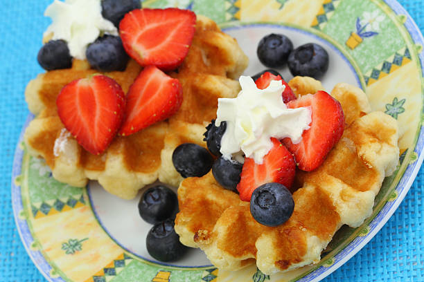 istock Wafers with strawberries, blueberries and whipped cream 475428025