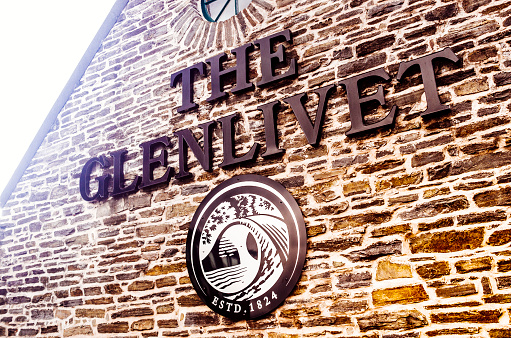 Tomintoul, United Kingdom - May 26, 2015: Glenlivet sign and emblem at the Glenlivet distillery near Tomintoul in Scotland. Located in the heart of whisky country (the word whisky derives from the Gaelic uisge beatha, meaning 'water of life') it is a popular 'must see' tourist destination.