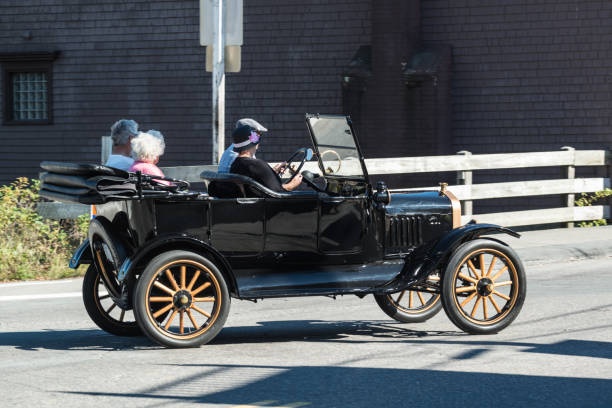 Ford Model T Mahone Bay, Canada - September 28, 2013: Four friends drive through the sleepy village of Mahone Bay in a 1920's Ford Model T. model t ford stock pictures, royalty-free photos & images