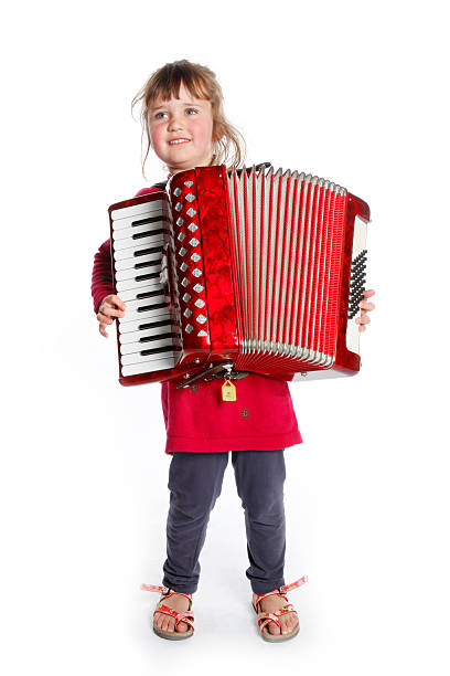 istock very young girl with accordion in studio 475428640