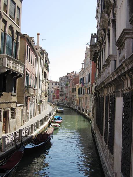 istock Small Canal in Venice, old and beautiful under blue sky 475428922