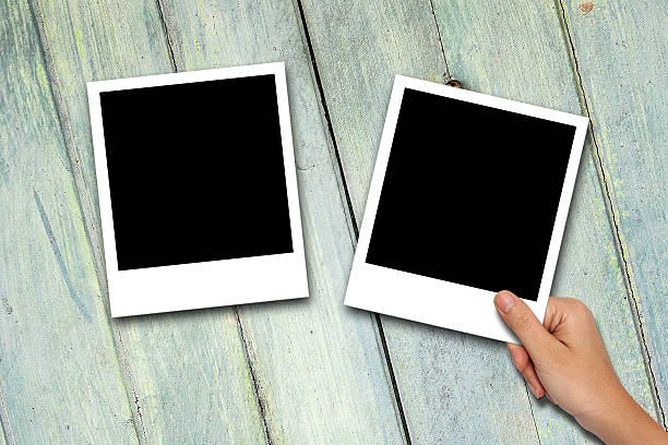 istock Blank photo frames on wood background 475428994