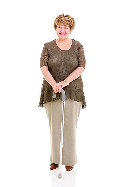 istock senior woman with walking stick 475429027