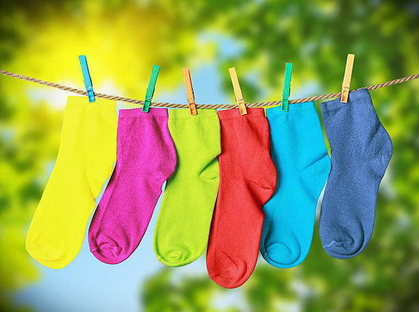 istock colorful socks hanging from a rope 475430182