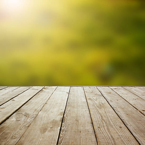 istock Wooden perspective floor with planks on blurred background 475430352