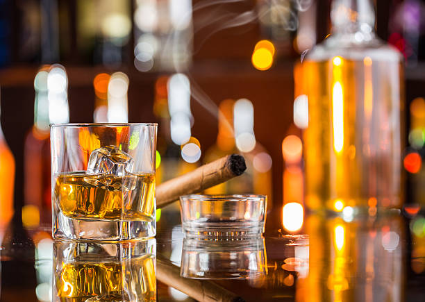istock Whiskey drink with smoking cigar on bar 475430710