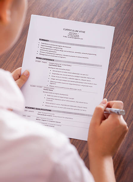 istock Young Businesswoman Reading Curriculum Vitae 475434326