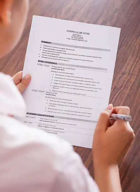 Photo of Young Businesswoman Reading Curriculum Vitae