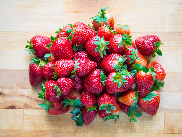 Pile of strawberries on wooden board