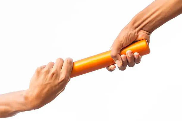 Cropped close-up of two male hands passing a relay baton against a white background.
