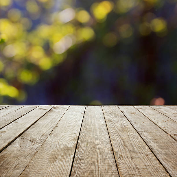 istock Wooden perspective floor with planks on blurred background 475435356