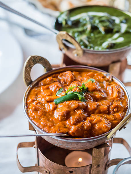istock Indian prawn curry and palak paneer in copper bowls 475437040