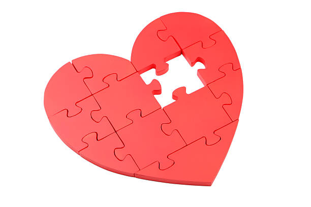 istock Red puzzle heart isolated on white 475437252