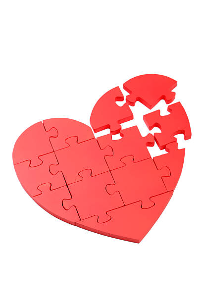 istock Red puzzle heart isolated on white 475437256