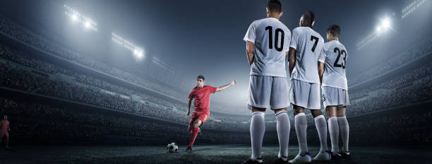 istock Soccer player kicking ball in stadium 475437658