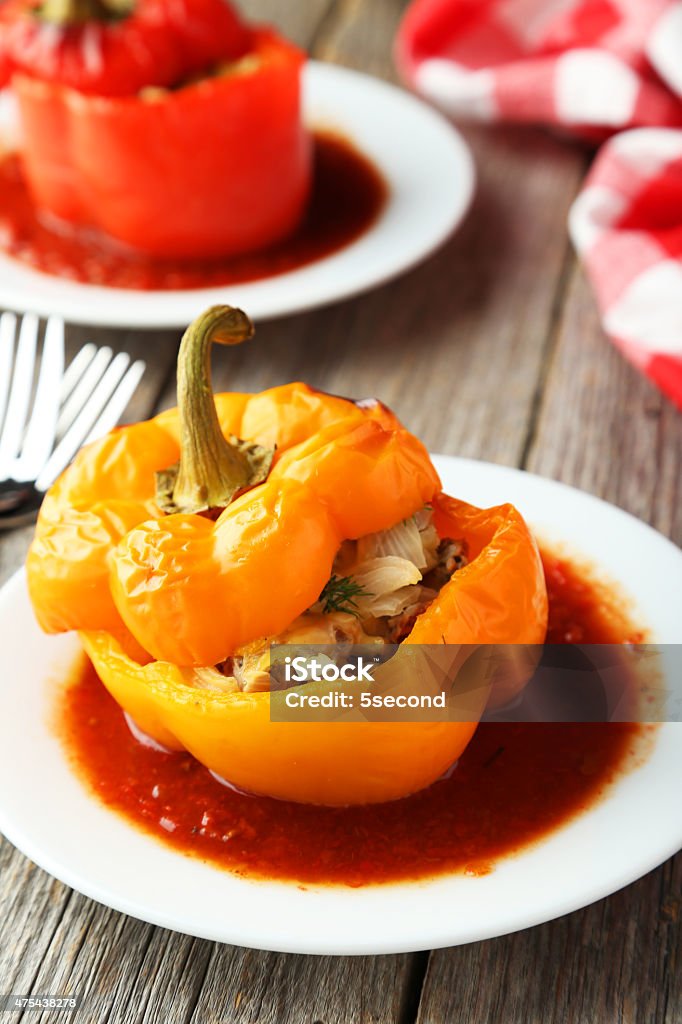 Red and yellow peppers Red and yellow peppers stuffed with meat, rice and vegetables 2015 Stock Photo