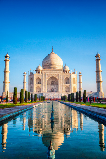The Taj Mahal with reflection in courtyard pool in Agra, India.