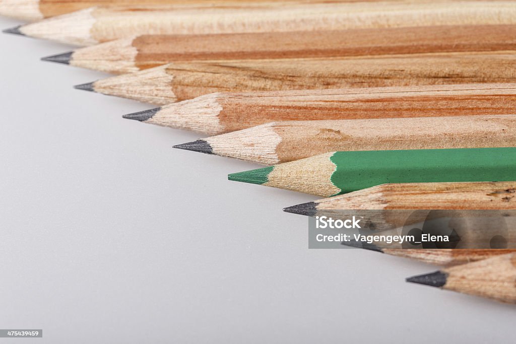 Show up Color pencil stands out against a series of graphite pencils Art Stock Photo