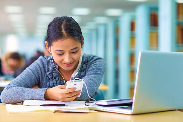 istock pretty female college student in library 475440176