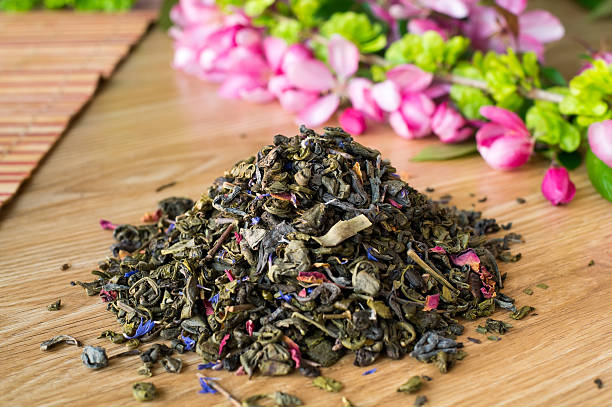 istock Blend of green tea on a table with colours. 475440284