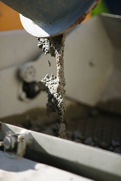 istock Hardworking laborer and truck-concrete mixer on construction site 475440312
