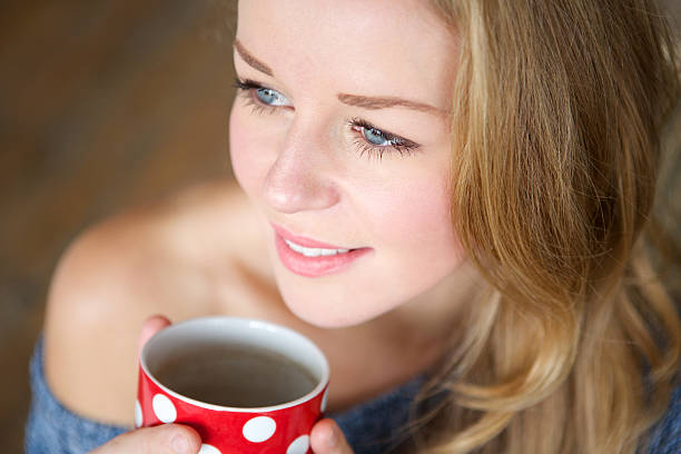 istock Woman relaxing with a cup of coffee 475440409