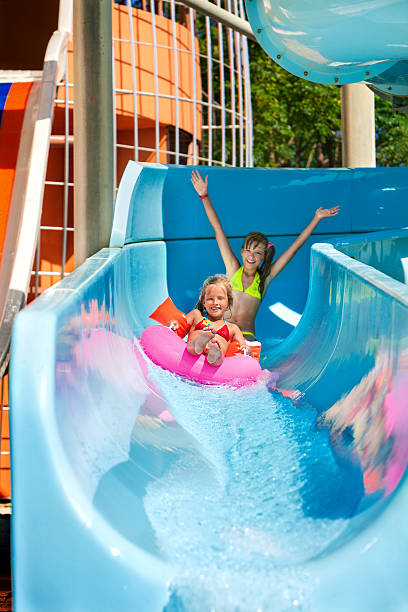 istock Child on water slide at aquapark 475440416