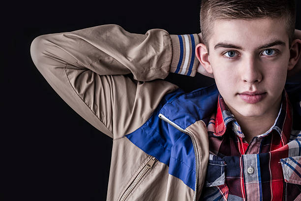 istock young man portrait on black background 475440873