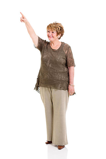 istock senior woman pointing up 475441459