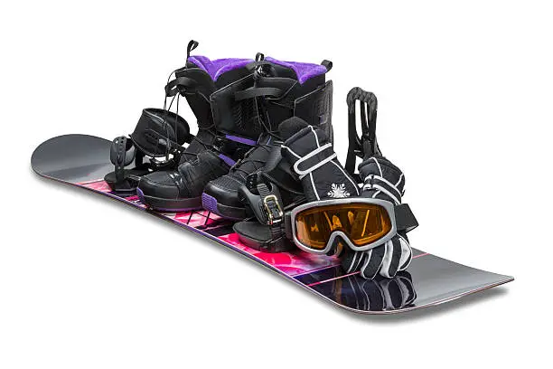Snowboard with boot, gloves and goggles isolated on white with clipping path.