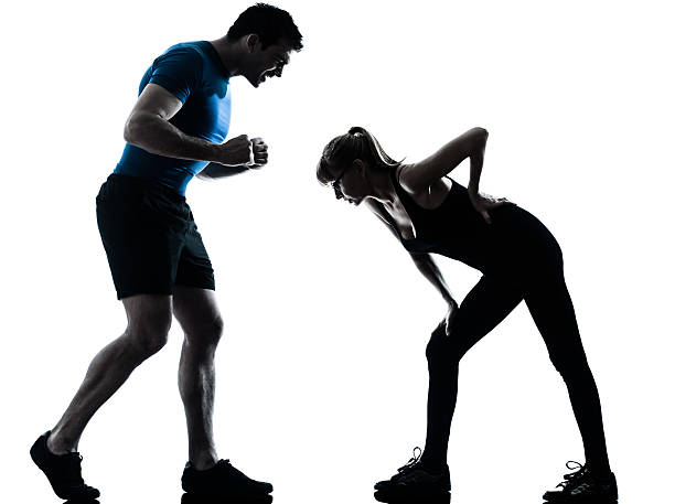 istock aerobics intstructor with mature woman exercising silhouette 475443507