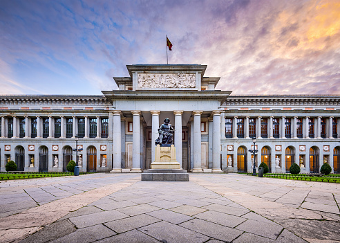 Madrid, Spain - November 18, 2014: The Prado Museum facade at the Diego Velaszquez memorial. Established in 1819, the museum is considered the best collection of Spanish art and one of the world's finest collections of European art.