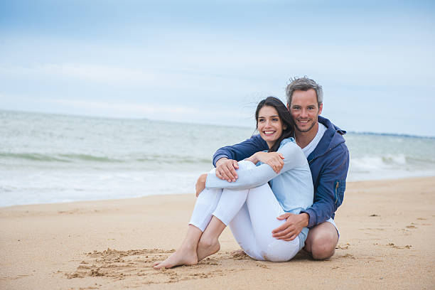 istock beautiful couple is holding eachother at the beach 475445214