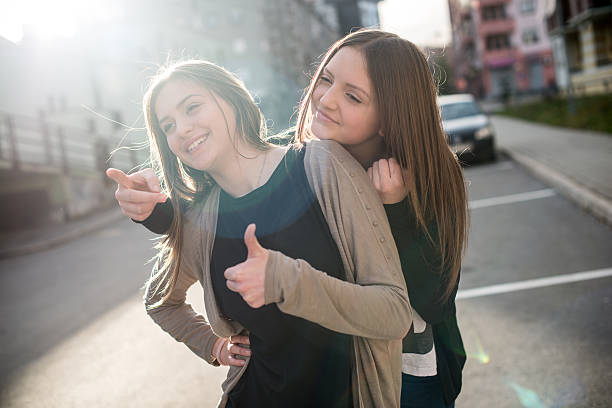 istock Girl pointing something other girl 475447294