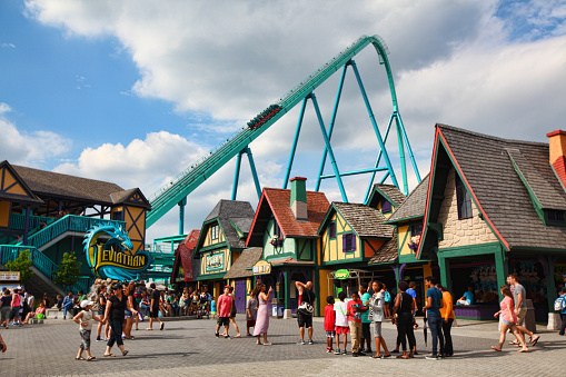 Niagara Falls, Canada - August 14, 2022: View along a street in Niagara Falls in Canada. The street is crowded with people and on both sides are many restaurants and shops.