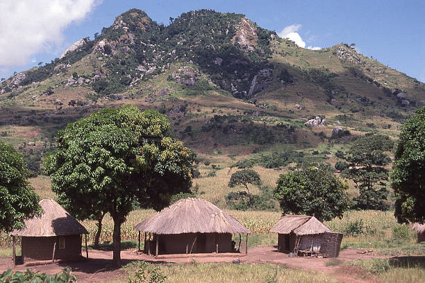 Thatch Roof Huts and farmland rocky hills Togo West Africa Thatch Roof Huts and farmland on rocky outcropping hills Togo West Africa togo stock pictures, royalty-free photos & images