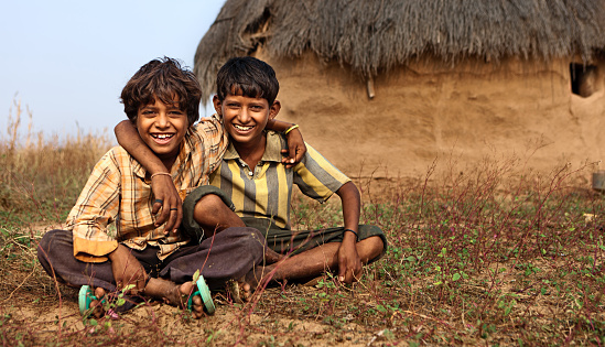 Portrait of two Indian young boys sitting next to the hut - desert village, Thar Desert, Rajasthan, India.http://bem.2be.pl/IS/rajasthan_380.jpg