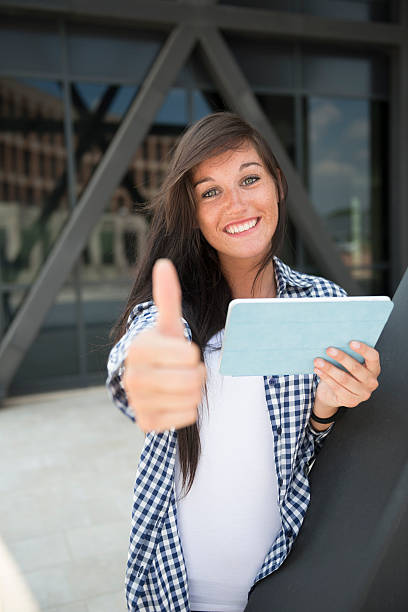istock Young happy woman with thumbs up 475449313