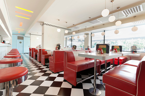 american diner restaurant style in black and white tiles and red booths