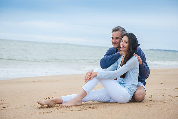 istock beautiful couple is holding eachother at the beach 475451538