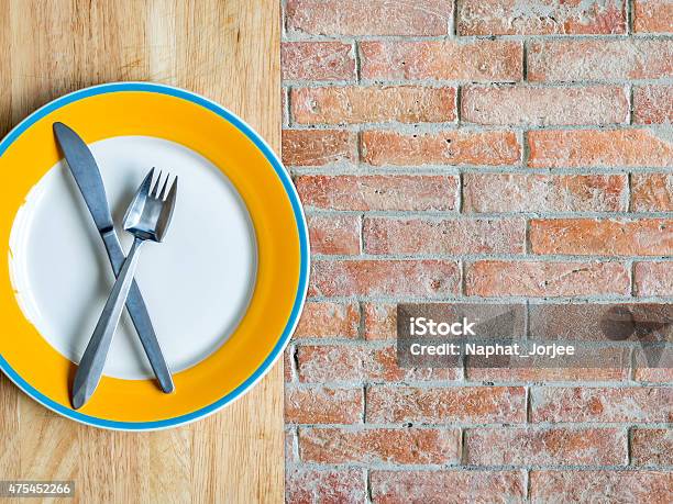 Blank Plate On Wooden Top Rustic Brick Copy Space Background Stock Photo - Download Image Now