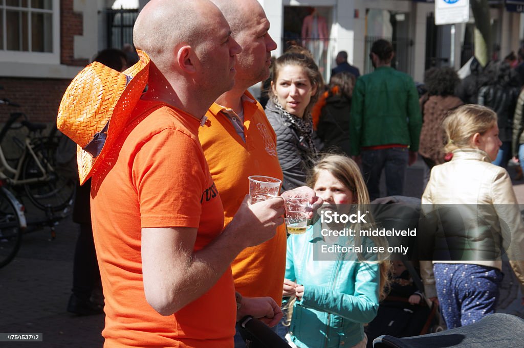 Koningsdag in the city of Haarlem Haarlem, the Netherlandsy - April 27, 2015: Koningsdag in the city of Haarlem with celebrating people. As you can see the traditional color is orange an there is fun. 2015 Stock Photo